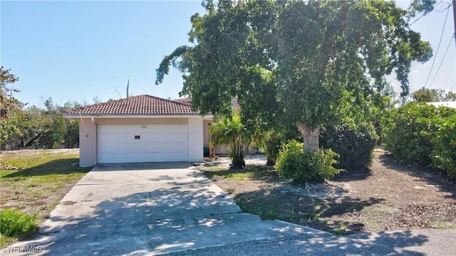 view of front of house with a garage and a tiled roof