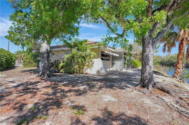 view of property exterior featuring a tiled roof and stucco siding