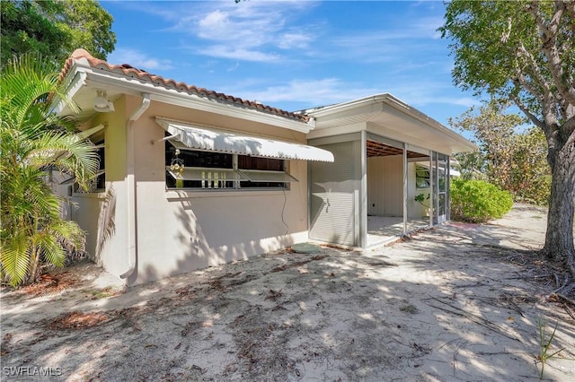 view of home's exterior featuring a tile roof