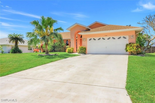 view of front of property featuring stucco siding, driveway, a garage, and a front yard