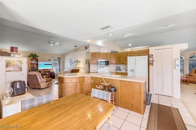 kitchen with visible vents, open floor plan, white appliances, light tile patterned floors, and lofted ceiling