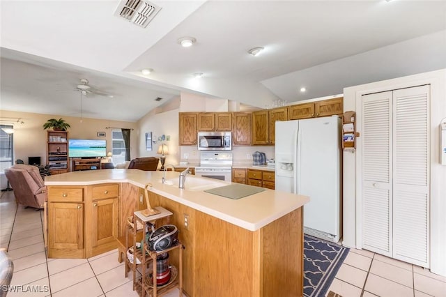 kitchen featuring visible vents, open floor plan, white appliances, light countertops, and lofted ceiling