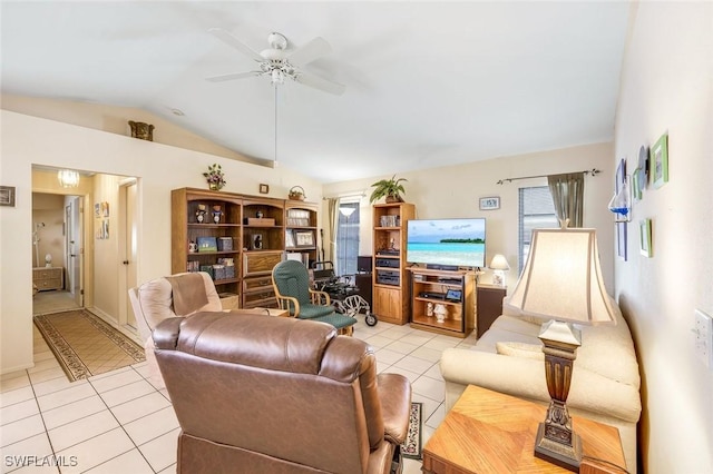 living area featuring lofted ceiling, light tile patterned floors, and ceiling fan