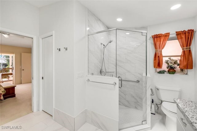 bathroom featuring recessed lighting, a shower stall, toilet, and vanity