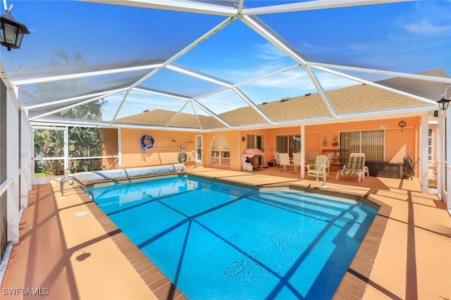 outdoor pool featuring a patio area and a lanai