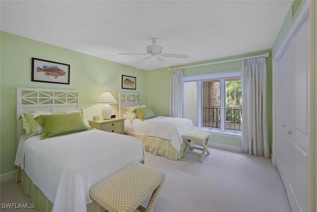 carpeted bedroom featuring ceiling fan, a closet, and baseboards