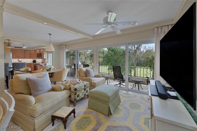 sunroom with ceiling fan and beamed ceiling