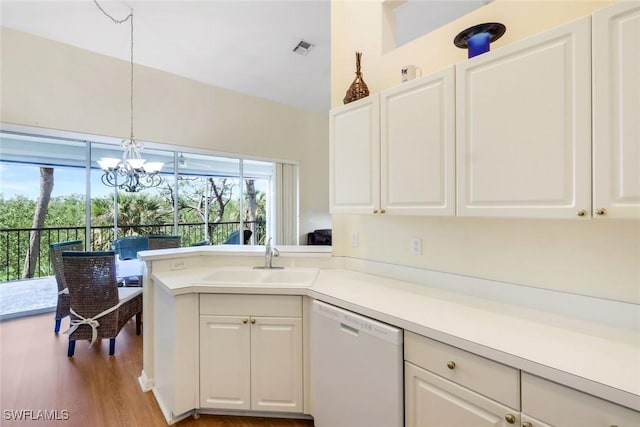 kitchen featuring dishwasher, light countertops, a sink, and white cabinetry