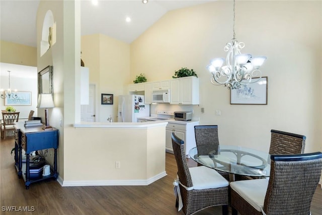 dining room featuring baseboards, high vaulted ceiling, dark wood-type flooring, and an inviting chandelier