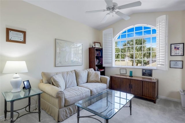 living room featuring vaulted ceiling, baseboards, a ceiling fan, and light colored carpet