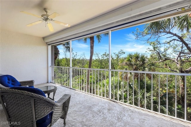 sunroom featuring ceiling fan