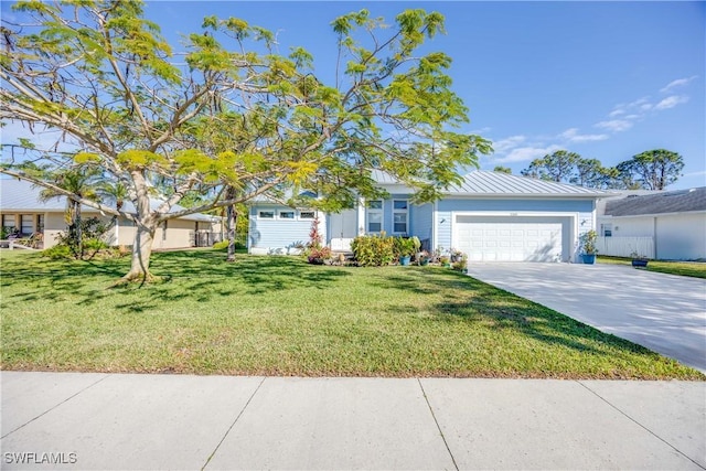 view of front of property with driveway, a standing seam roof, a garage, and a front yard