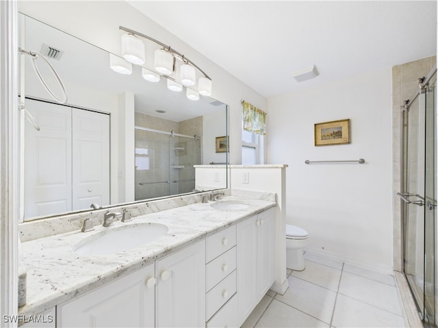 full bath with double vanity, tile patterned flooring, a sink, and a shower stall