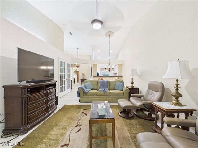 tiled living room with high vaulted ceiling, french doors, visible vents, and an inviting chandelier