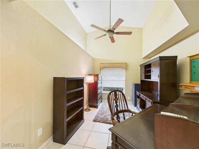 office area with light tile patterned floors, visible vents, ceiling fan, high vaulted ceiling, and baseboards