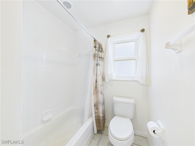 bathroom with toilet, shower / tub combo, baseboards, and tile patterned floors