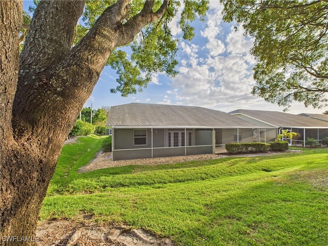 view of front of home with a front yard and a lanai