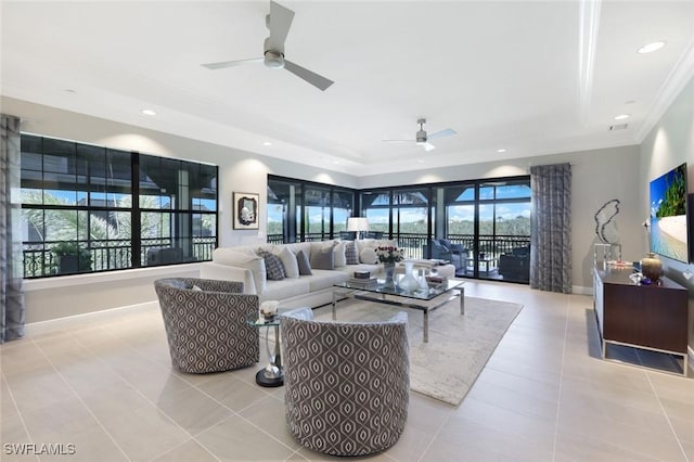 16445 Carrara Way Unit 201, Naples, FL 34110 - living room featuring a ceiling fan, light tile patterned flooring, ornamental molding, a tray ceiling, and baseboards