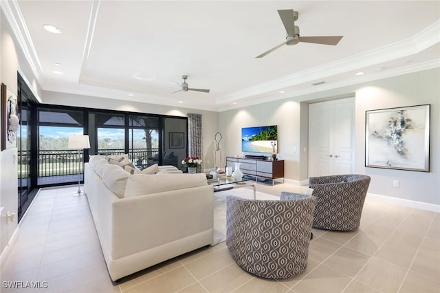 living area featuring ornamental molding, a tray ceiling, recessed lighting, baseboards, and ceiling fan