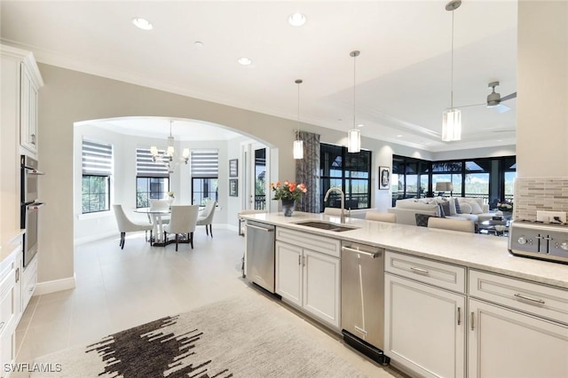 16445 Carrara Way Unit 201, Naples, FL 34110 - kitchen with a sink, arched walkways, a chandelier, stainless steel appliances, and open floor plan