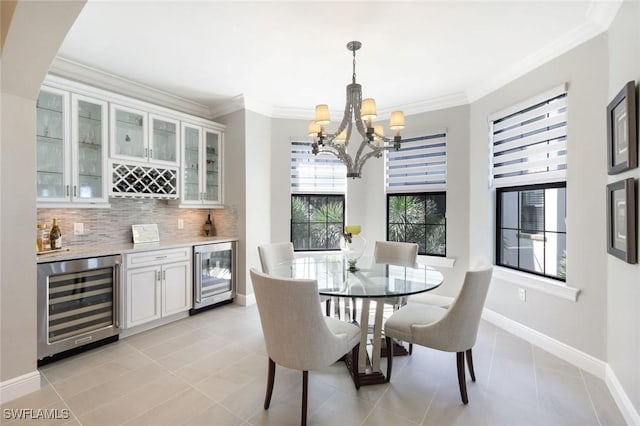 16445 Carrara Way Unit 201, Naples, FL 34110 - dining area featuring wine cooler, a chandelier, a dry bar, light tile patterned flooring, and ornamental molding