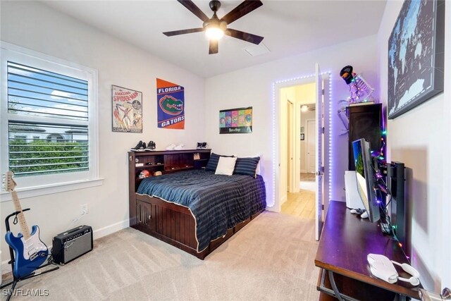 carpeted bedroom featuring ceiling fan and baseboards