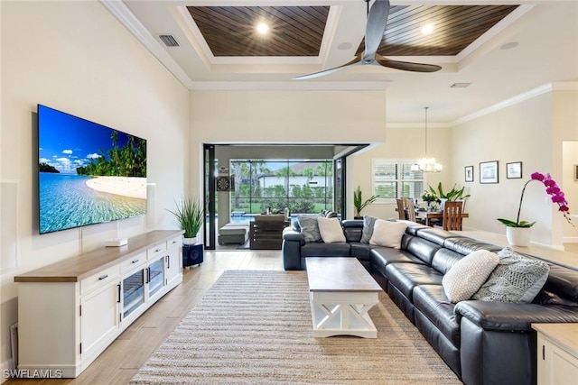 living area featuring wooden ceiling, light wood-style flooring, ornamental molding, and a raised ceiling