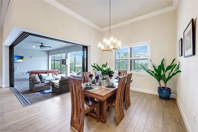 dining space with baseboards, a healthy amount of sunlight, light wood-type flooring, and crown molding