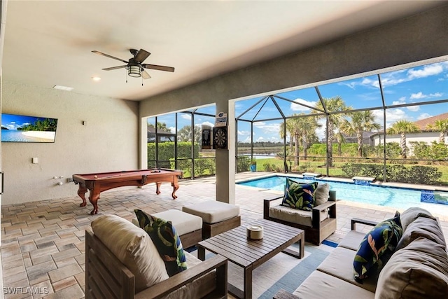 view of patio with an outdoor pool, glass enclosure, an outdoor living space, and a ceiling fan