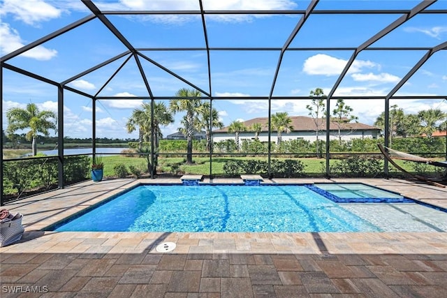 view of pool with a water view, glass enclosure, a pool with connected hot tub, and a patio