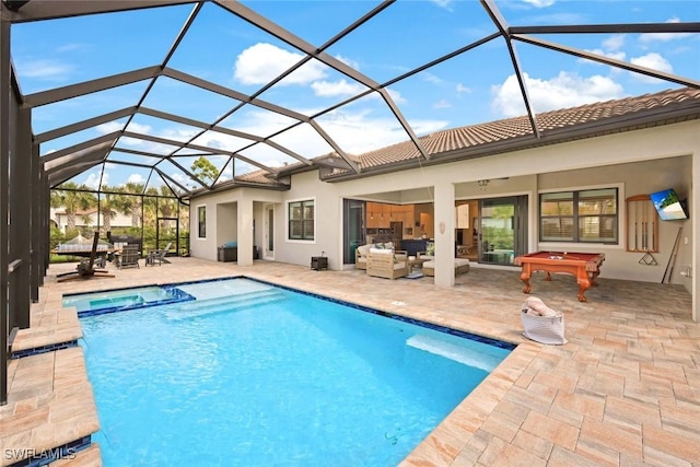 view of pool featuring a patio, glass enclosure, a pool with connected hot tub, and an outdoor living space