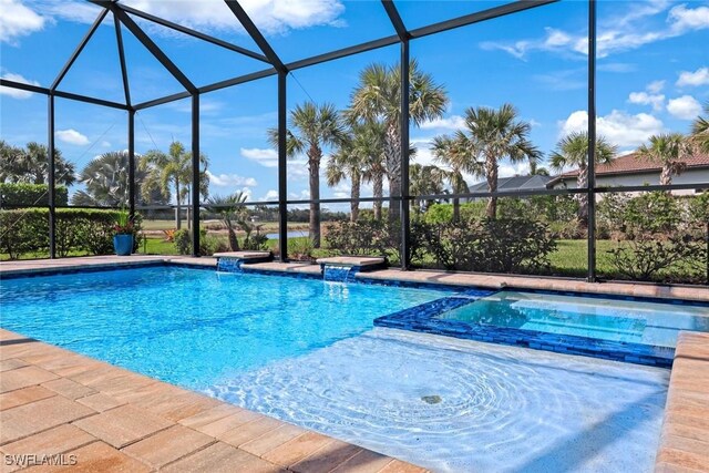 view of pool featuring a lanai and a pool with connected hot tub