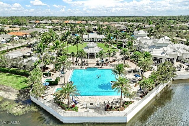 birds eye view of property with a water view and a residential view