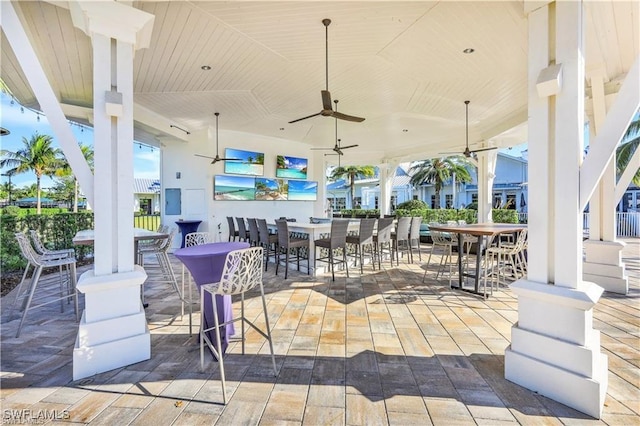 9151 Snowy Owl Way, Naples, FL 34120 - view of patio / terrace with a bar and a ceiling fan