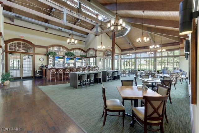 9151 Snowy Owl Way, Naples, FL 34120 - dining area with a notable chandelier, beam ceiling, high vaulted ceiling, wooden ceiling, and wood finished floors