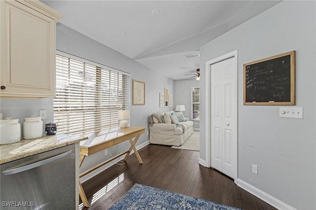 living area featuring ceiling fan, dark wood-type flooring, visible vents, baseboards, and vaulted ceiling