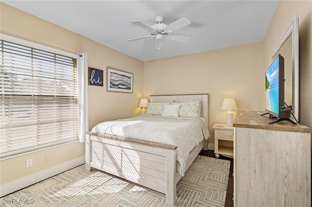 bedroom featuring a ceiling fan and baseboards