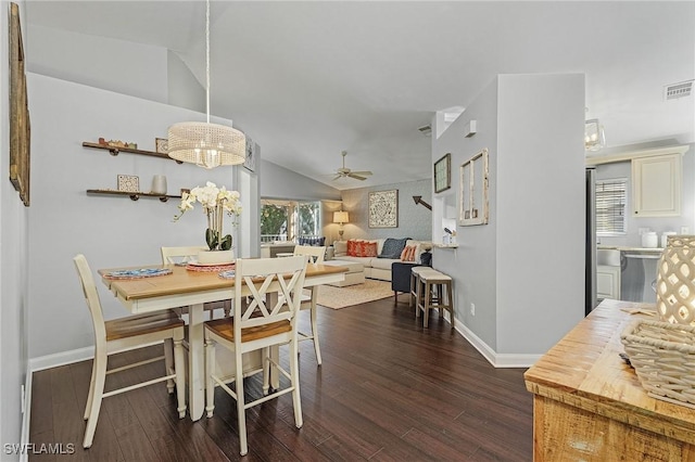 dining room featuring lofted ceiling, dark wood-style floors, and a healthy amount of sunlight