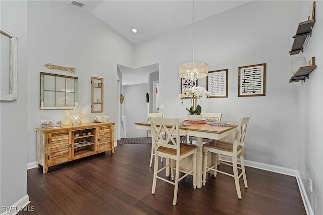 dining room with dark wood-style floors, a chandelier, visible vents, and baseboards