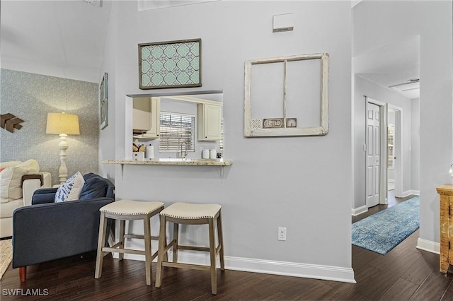 interior space featuring baseboards and wood finished floors