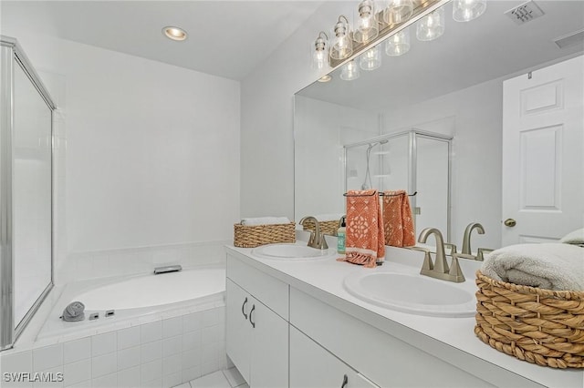 bathroom with a stall shower, visible vents, a sink, and a bath