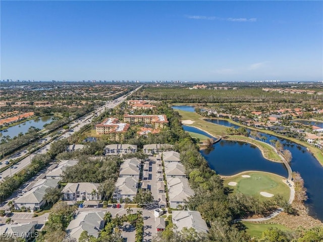 aerial view with a water view, view of golf course, and a residential view