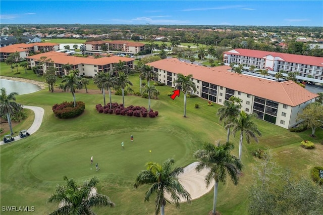 drone / aerial view featuring view of golf course and a water view