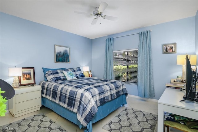 bedroom featuring light tile patterned flooring, a ceiling fan, and baseboards