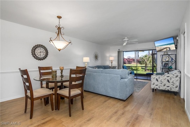 dining area with light wood-style flooring and baseboards