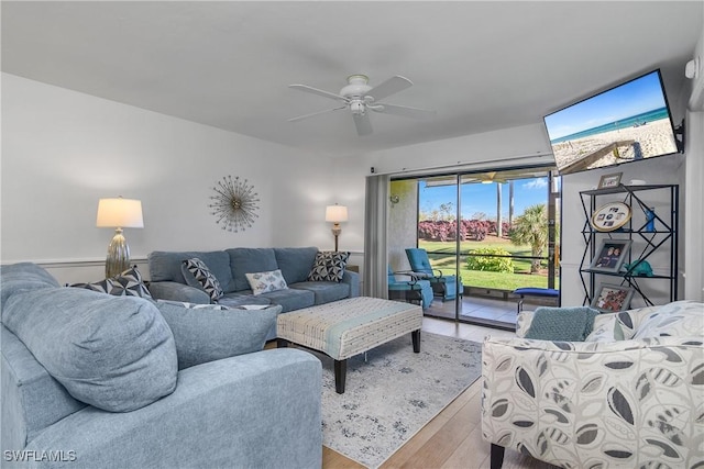 living room with wood finished floors and a ceiling fan