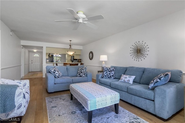 living area featuring ceiling fan, visible vents, and wood finished floors