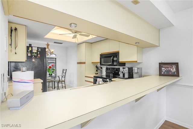 kitchen with black appliances, light countertops, visible vents, and a ceiling fan