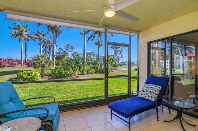 sunroom featuring a ceiling fan