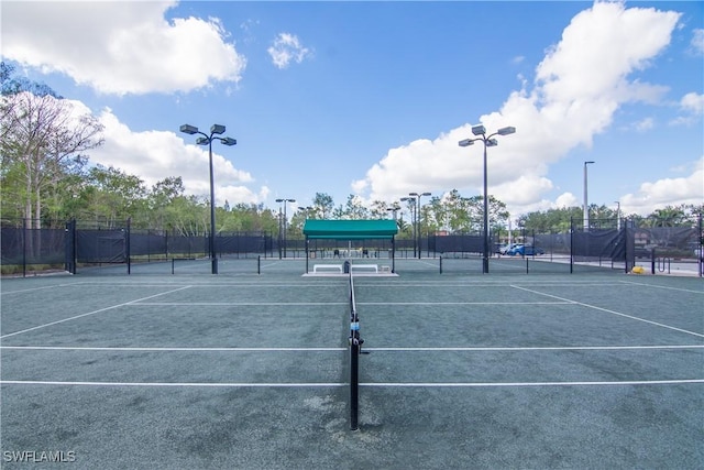 view of sport court featuring fence